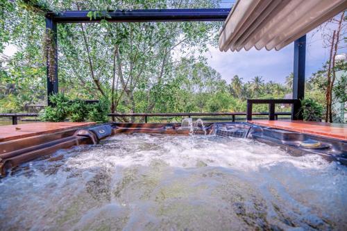 a plunge pool in a backyard with a water slide at DAMNERNPAWA in Bang Khon Thi