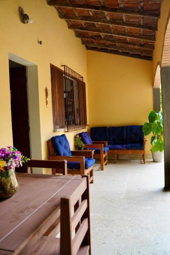 a living room with blue couches and a table at Pousada Villa Bella in Maricá