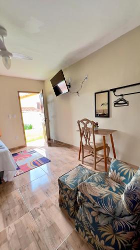 a living room with a couch and a table at Pousada Villa Bella in Maricá
