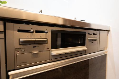 a microwave oven sitting on top of a wall at Takasago Utopia Hotel in Tokyo