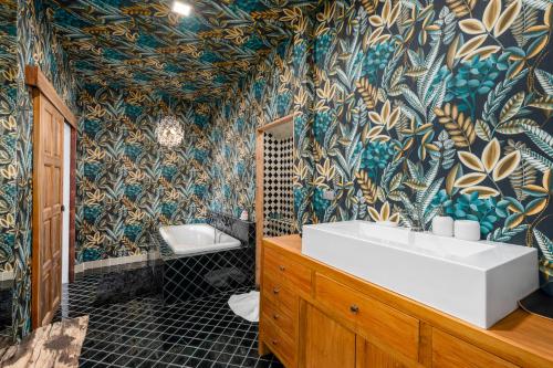 a bathroom with a tub and a sink and a toilet at Moorea Boutique Resort Samui in Ban Tai