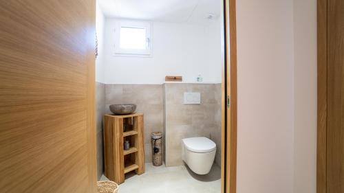 a small bathroom with a toilet and a window at Fortuna Residence in Saint-Tropez
