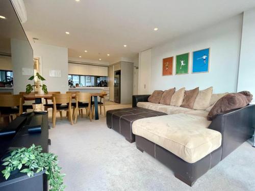 a living room with a couch and a dining room at Riverside Retreat in Melbourne