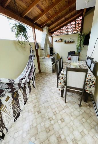 a patio with a table and chairs in a room at Residência in São José