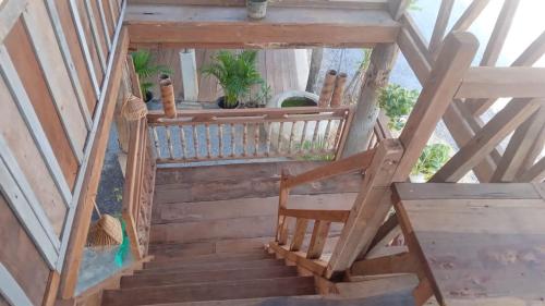 an overhead view of a wooden staircase with a chair at Battambang Eco Stay &cooking class in Battambang