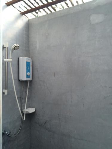 a bathroom with a shower in a wall at Fern House Retreat in Chalong 