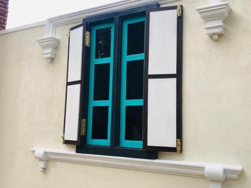 a blue window on the side of a building at Resolve Garden Hotel in Dodangoda