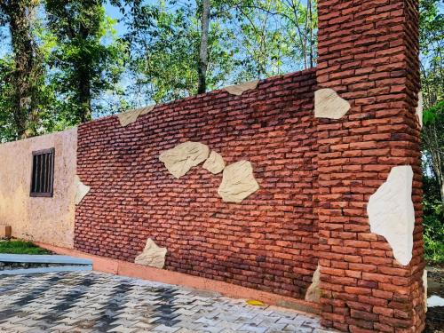 a brick wall with rocks on the side of it at Resolve Garden Hotel in Dodangoda