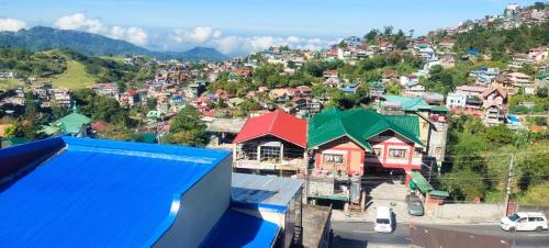 a group of houses on a hill in a town at Hut on the Hill Baguio City in Baguio