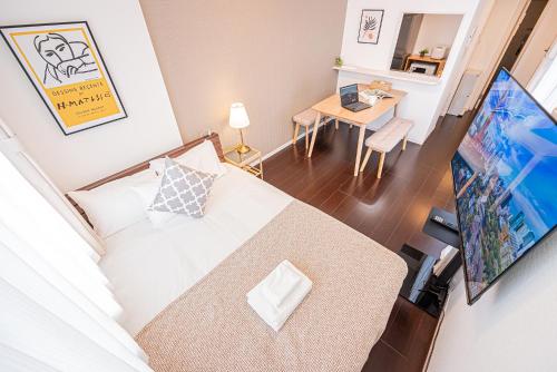 a small room with a bed and a table at Wasabi Sky Oshiage 押上駅徒歩アパート in Tokyo