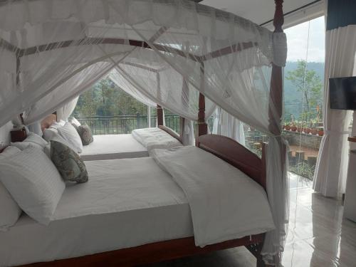a bedroom with a canopy bed with a window at Tea Hills Lake in Hatton