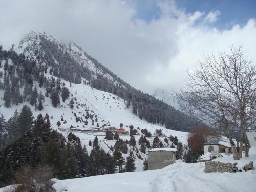 a snow covered mountain with a town on it at Gilgit Serena Hotel in Gilgit