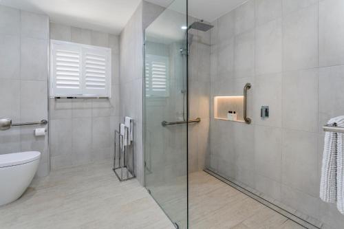 a bathroom with a glass shower and a toilet at Keith's Place, 1 of the 3 most popular units on Bribie in Bongaree