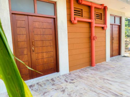 a pair of doors on a house with pipes at Resolve Garden Hotel in Dodangoda