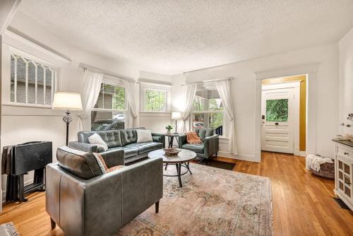 a living room with a couch and a table at Madison Manor in Siloam Springs