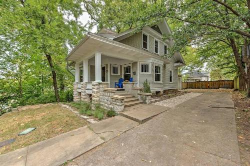 a white house with a porch and a driveway at Madison Manor in Siloam Springs