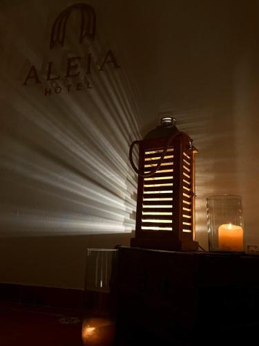 a lit candle and a lit up object on a table at Hotel ALEIA Centro in Taxco de Alarcón