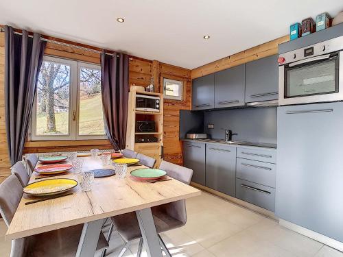 une cuisine avec une table en bois et un réfrigérateur dans l'établissement La Clusaz : Appartement 6 pers, Mezzanine, Terrasse Sud - FR-1-818-7, à La Clusaz