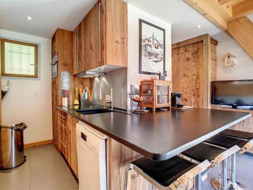 une cuisine avec un grand comptoir noir dans l'établissement Duplex cosy 6 pers, 2 ch, garage, La Clusaz - FR-1-818-20, à La Clusaz