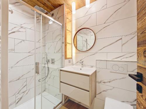 a bathroom with a shower and a sink and a mirror at Appartement 8 pers rénové, 2 ch, accepte animaux, garage - La Clusaz - FR-1-818-21 in La Clusaz
