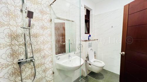 a bathroom with a toilet and a sink and a shower at M8 Espacio 03 Bedrooms Apartments in Wellawatta