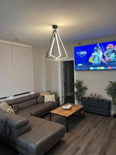 a living room with a couch and a tv at Chic Retreat in Chicago