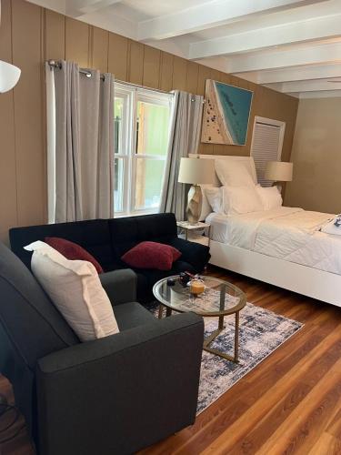 a living room with a bed and a couch at Spacious comfortable Studio Unit in Tallahassee