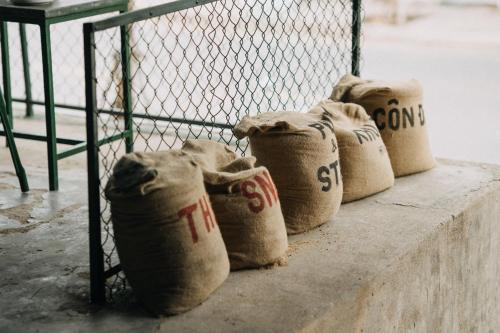 a group of wrapped hay bags sitting next to a fence at The Snail Haven Pub And Stay - Con Dao in Con Dao