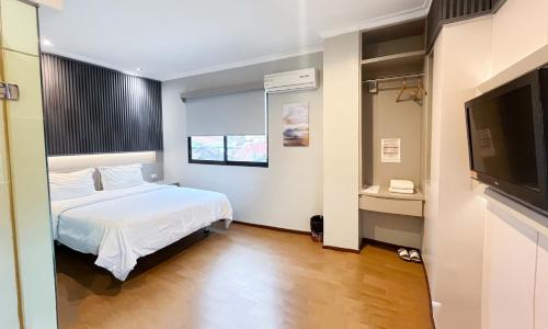 Postel nebo postele na pokoji v ubytování G-Hotel Pontianak
