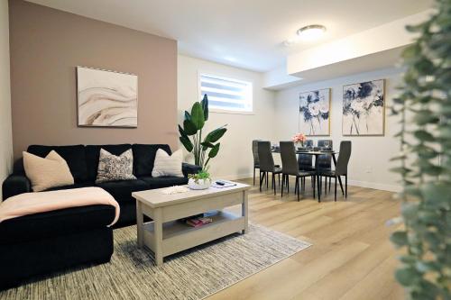 a living room with a couch and a table at Downtown Suite King Beds,Long Stays,Disney+ in Edmonton