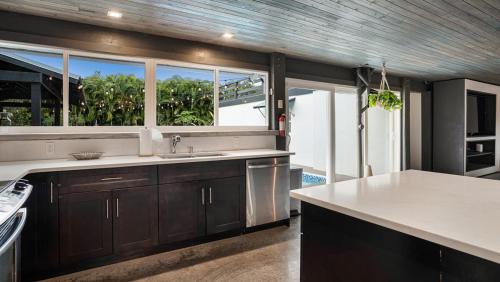 a kitchen with a sink and a large window at Luxury Tropical Oasis-4 BedRm Private Pool Retreat in Fort Myers