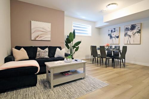 a living room with a couch and a table at Downtown 5 Bedroom, AC, Rogers, Commonwealth, EXPO in Edmonton