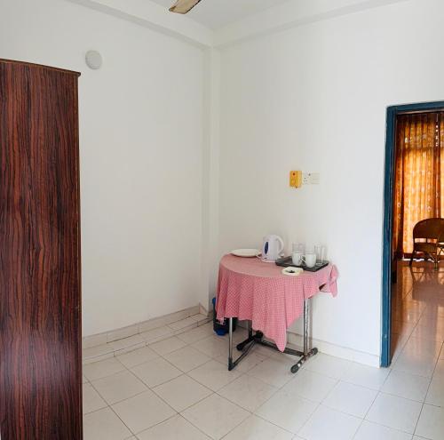 a table in a room with a pink table cloth at Relax Home in Sri Jayewardenepura Kotte