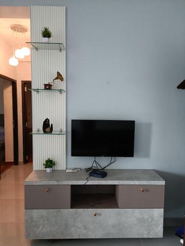 a entertainment center with a flat screen tv on top of it at Casa de Rhythm in Jodhpur