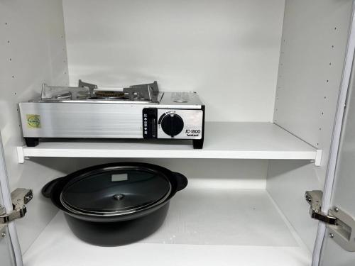 a toaster sitting on a shelf in a kitchen at くわみずの森 in Kumamoto