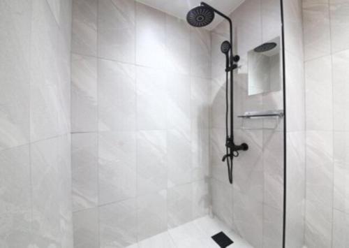 a bathroom with a shower with a glass door at LABE Hotel in Jeonju