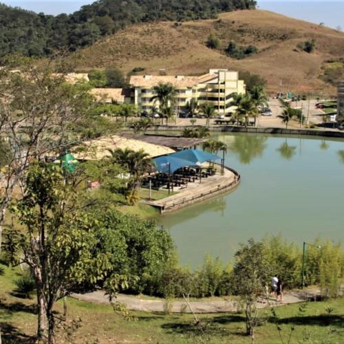 a large body of water with a building in the background at Flat no Village das Águas Resort ao lado do Parque Aquático Aldeia das Águas in Barra do Piraí