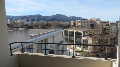 a balcony with a view of the city and mountains at Residence Services Calypso Calanques Plage in Marseille