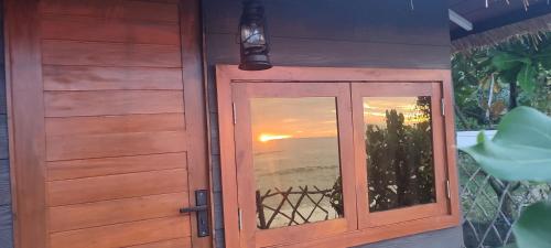 a door with a window with a view of the ocean at Tomorrowland Beach Villas in Tangalle