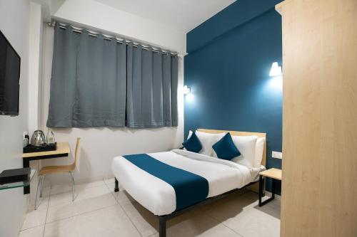 Postel nebo postele na pokoji v ubytování Hotel O C3 Celebration City Centre