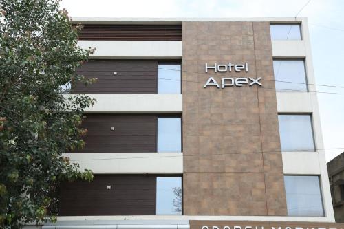 a hotel adx sign on the side of a building at Hotel New Apex in Ankleshwar