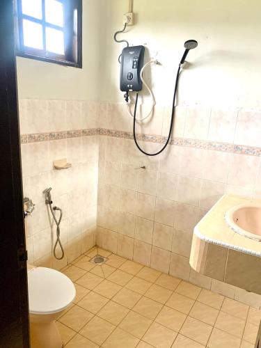 a bathroom with a shower and a toilet at AsiaCamp Taman Negara Resort in Kuala Tahan