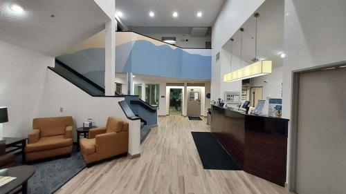 a living room with two chairs and a staircase at Sleep Inn Missoula Southgate in Missoula