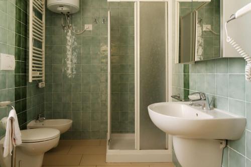 a bathroom with a sink and a toilet and a shower at Residence Marina Salivoli in Piombino