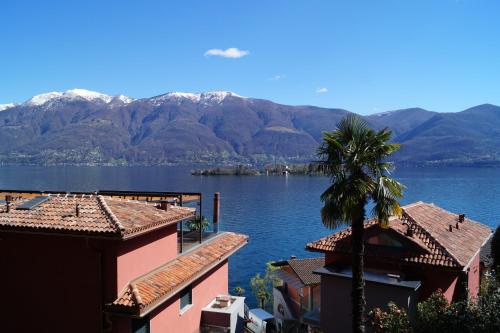 a view of a large body of water with mountains at Casa Eva in Ronco s/Ascona - Porto Ronco