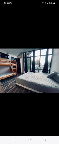a bedroom with a bed and a large window at La Belle Vie in Vartop