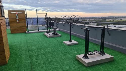 a balcony with three metal sculptures on a roof at Apartamento Familiar! in Pelotas