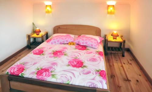 a bedroom with a bed with pink roses on it at Charming Villa in Foulpointe with Sea View in Foulpointe