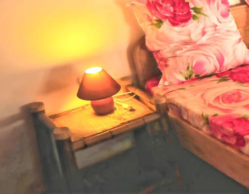 a lamp on a table next to a bed at Charming Villa in Foulpointe with Sea View in Foulpointe