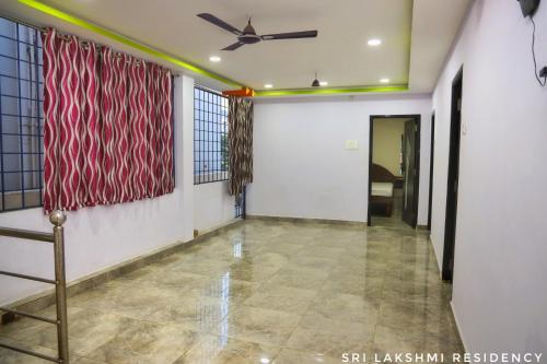a room with a ceiling fan and a flag on the wall at Sri Lakshmi Residency in Tirupati